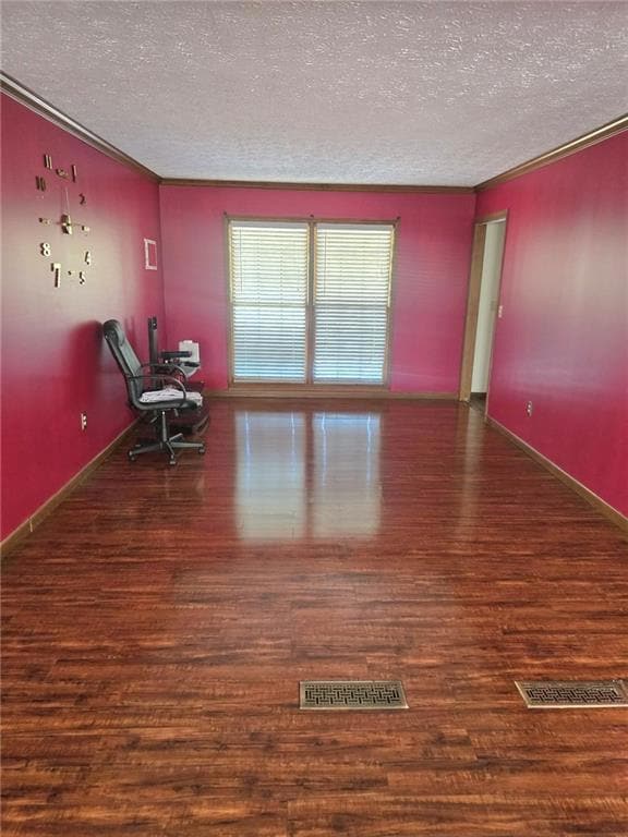 Empty room with ornamental molding, a textured cei