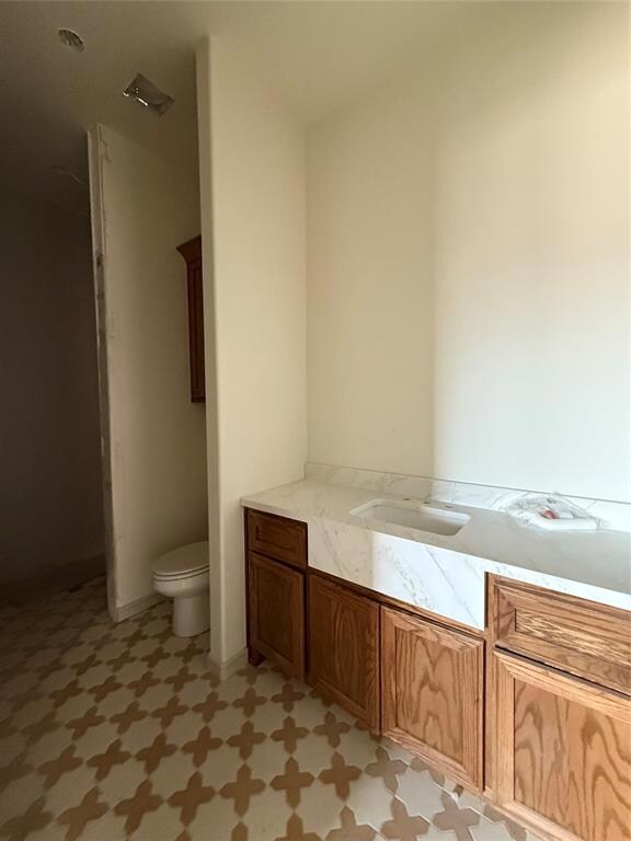 Bathroom with tile patterned floors, a sink, and t