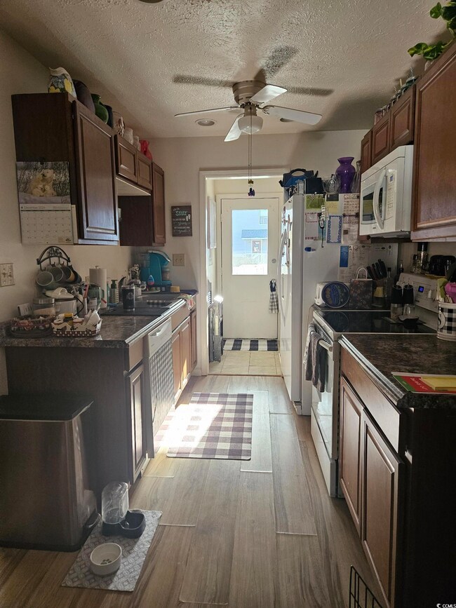 Kitchen featuring a textured ceiling, electric ran