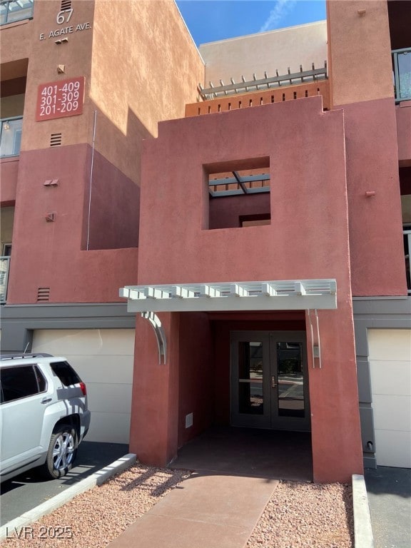 View of building exterior featuring an attached ga