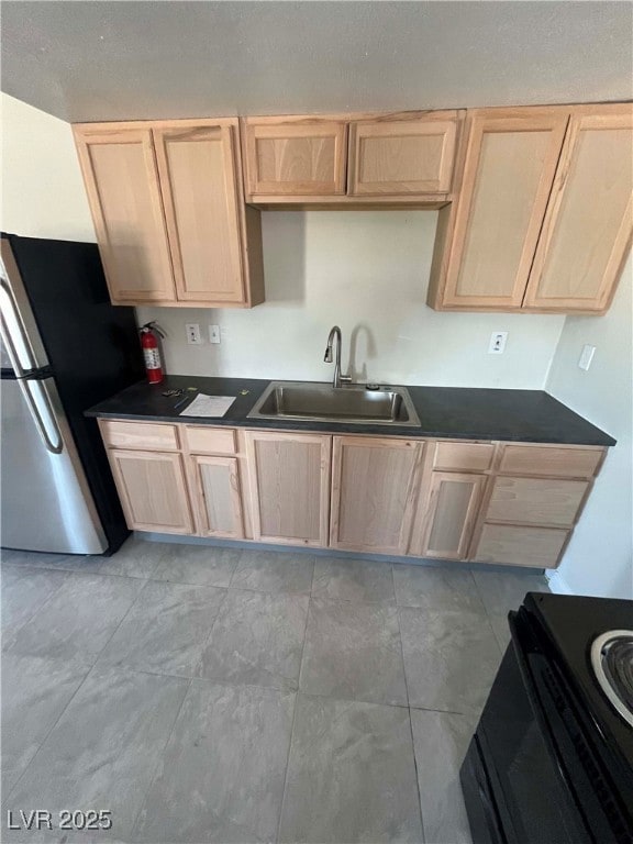 Kitchen featuring freestanding refrigerator, light