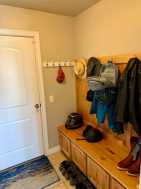 Mudroom with light tile patterned floors and baseboards