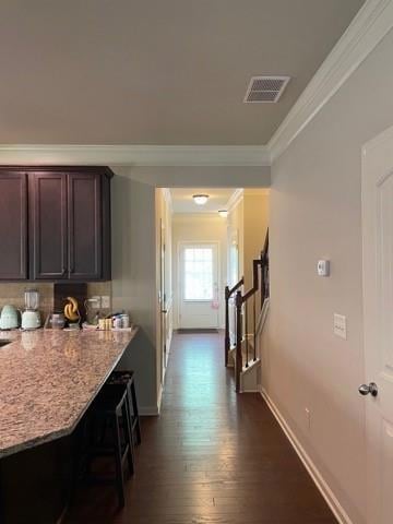 Hall featuring crown molding and dark wood-style floors