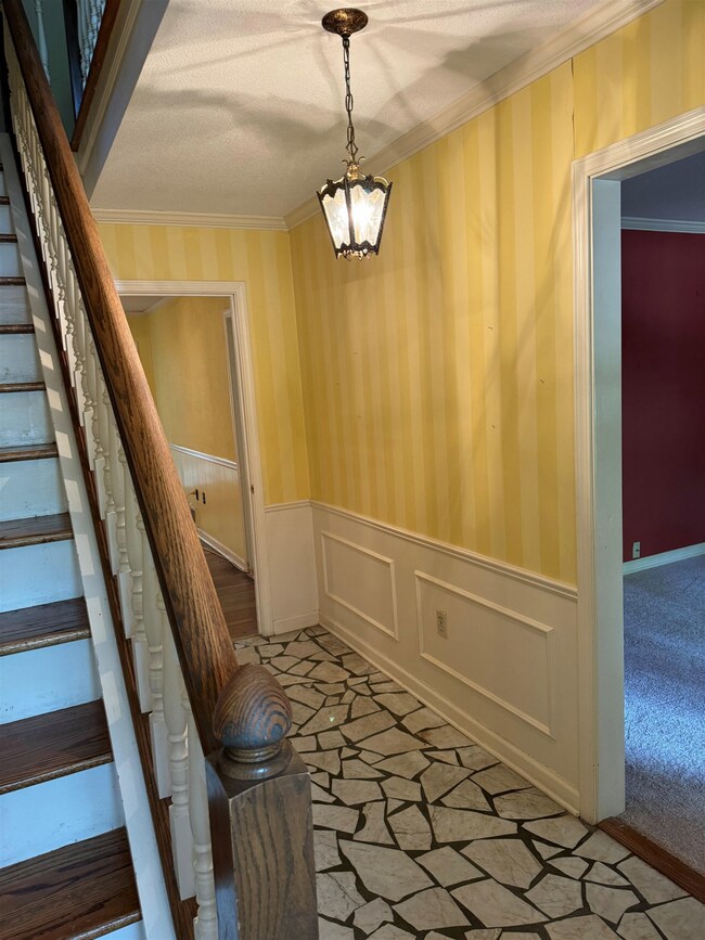Interior space featuring ornamental molding, a tex