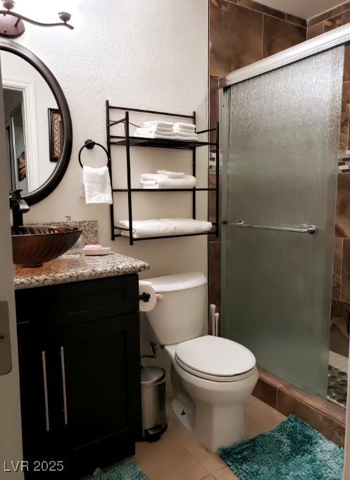 Bathroom featuring a stall shower, tile patterned