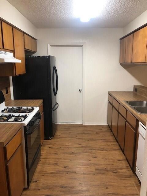 Kitchen with black gas range, under cabinet range