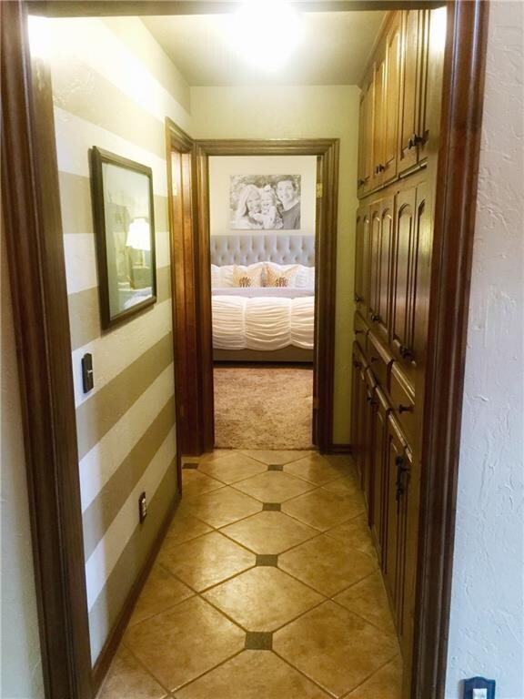 Hallway to master suite, half bath, and floor-to-c