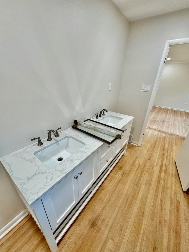 Bathroom with vanity and wood finished floors