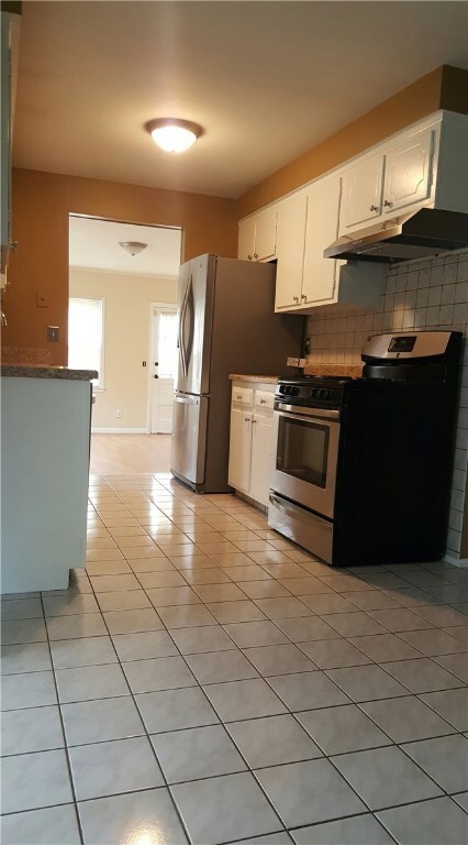 GALLEY KITCHEN WITH LARGE TILED EAT IN DINNING AND