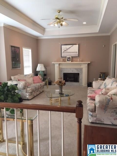 Large living room with a marble fireplace. Feature