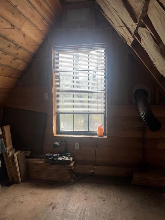 Additional living space featuring lofted ceiling and wood finished floors