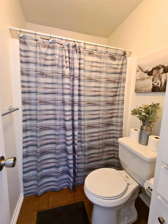 Full bathroom featuring tile patterned floors, cu