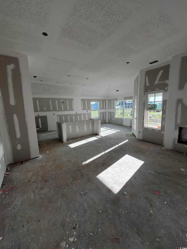 Unfurnished living room featuring a textured ceiling