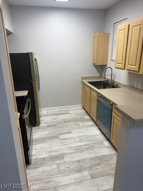 Kitchen featuring dishwasher, range, light brown cabinetry