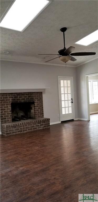 great room with skylights, fireplace, vaulted ceilings