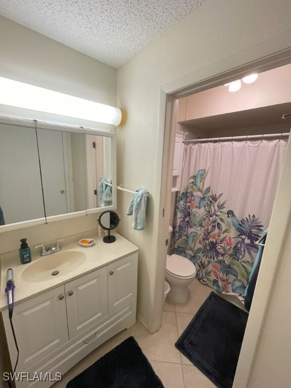 Full bathroom featuring tile patterned flooring, v