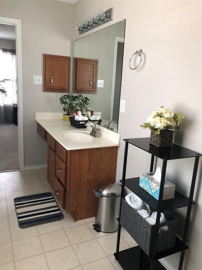 Bathroom featuring vanity and tile patterned floor
