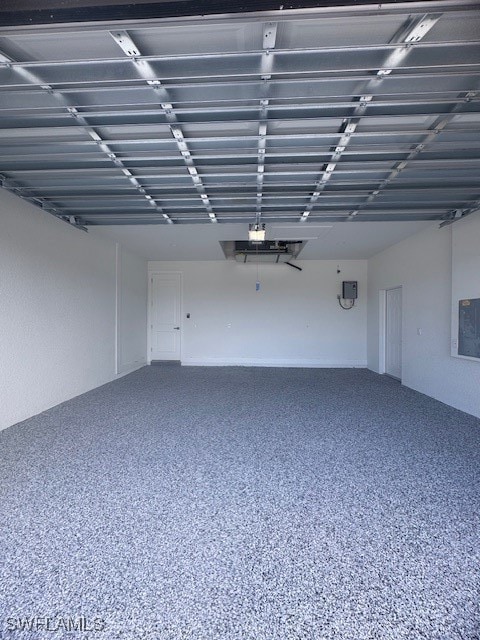 Garage featuring electric panel and a garage door