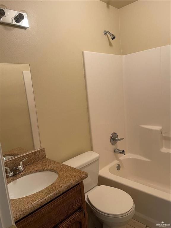 Bathroom featuring toilet, shower / bathtub combination, vanity, and tile patterned flooring