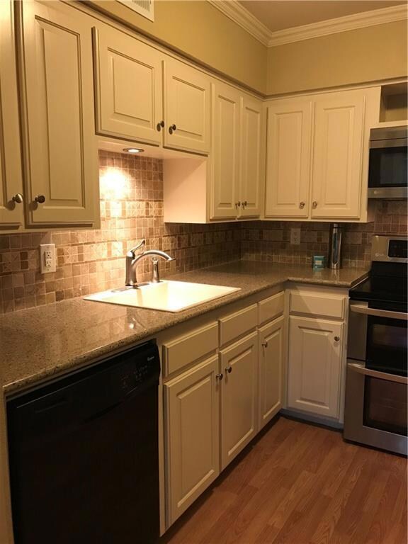 Kitchen with quartz counters double ovens Built I 