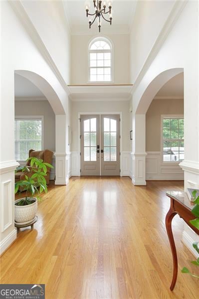 Two story foyer with hardwood floors and view to formal living and dining room