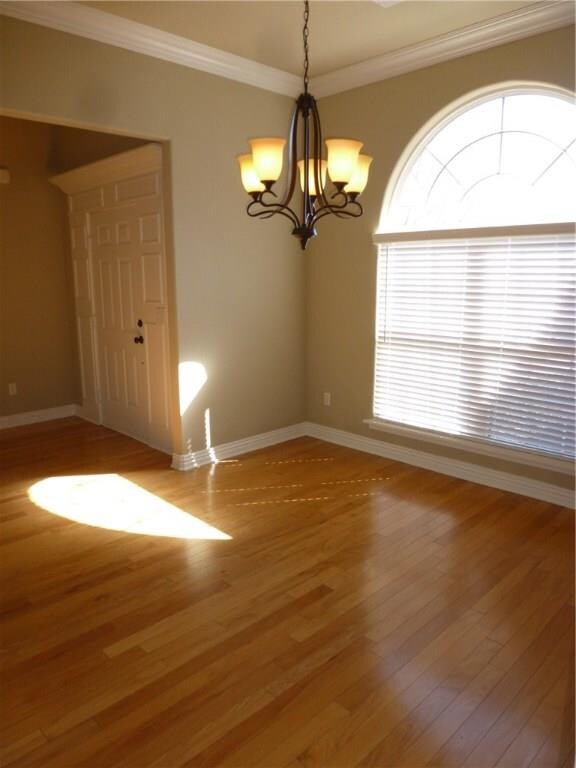 Formal dining room with large window overlooking front yard.