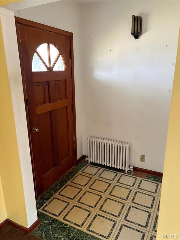 Foyer with radiator heating unit and baseboards