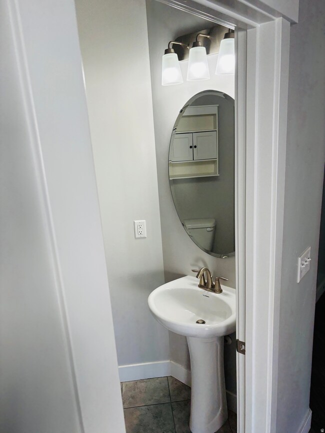Bathroom featuring tile patterned flooring and baseboards