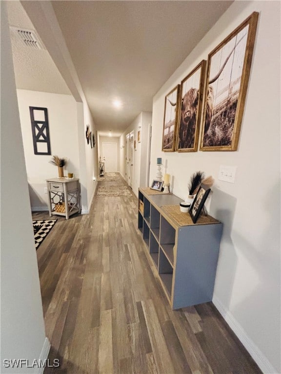 Hall with wood finished floors and baseboards