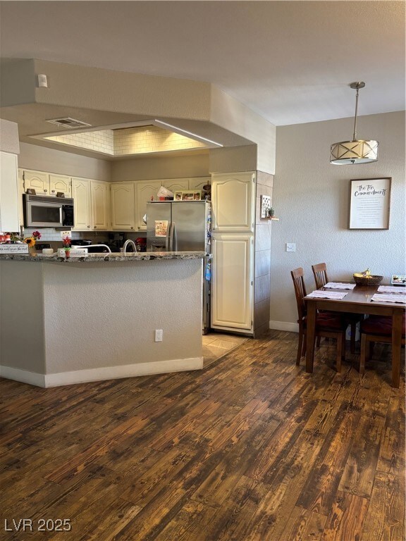 Kitchen with wood finished floors, stainless steel