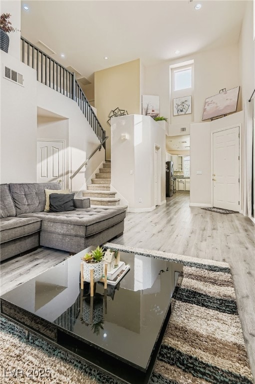 Living room featuring a high ceiling, wood finishe