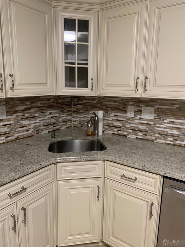 View of kitchen sink and dishwasher to the right of sink