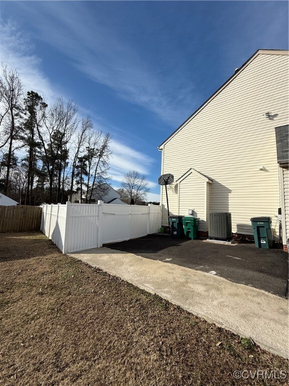 View of side of property with central AC unit