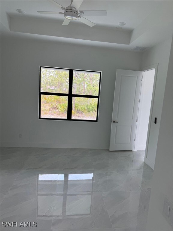 Unfurnished room with a raised ceiling, marble fin
