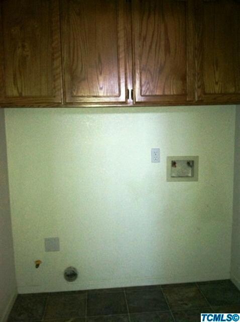 Indoor laundry room boasts plenty of sto