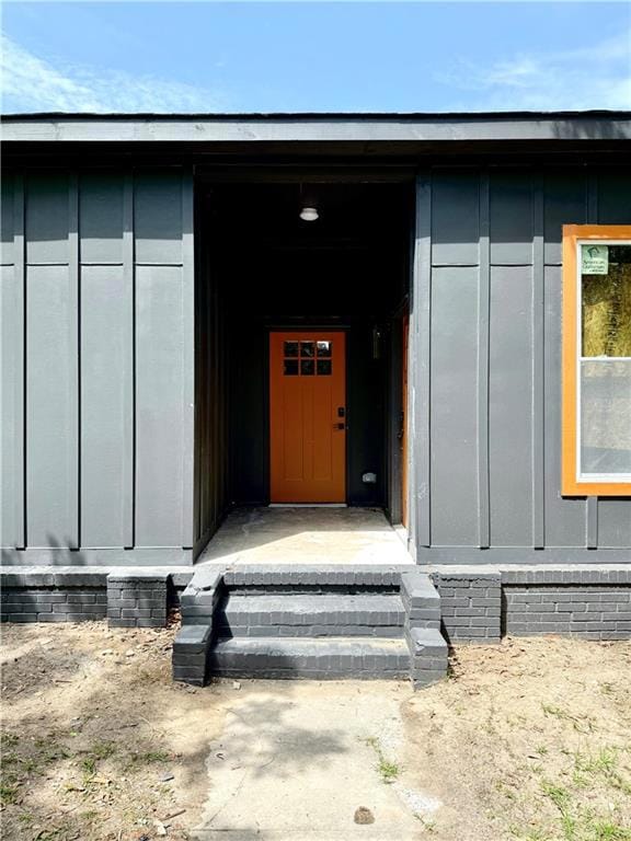 View of exterior entry with board and batten siding
