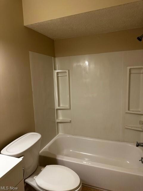 1st Full bathroom with vanity, shower / tub combination, and a textured ceiling