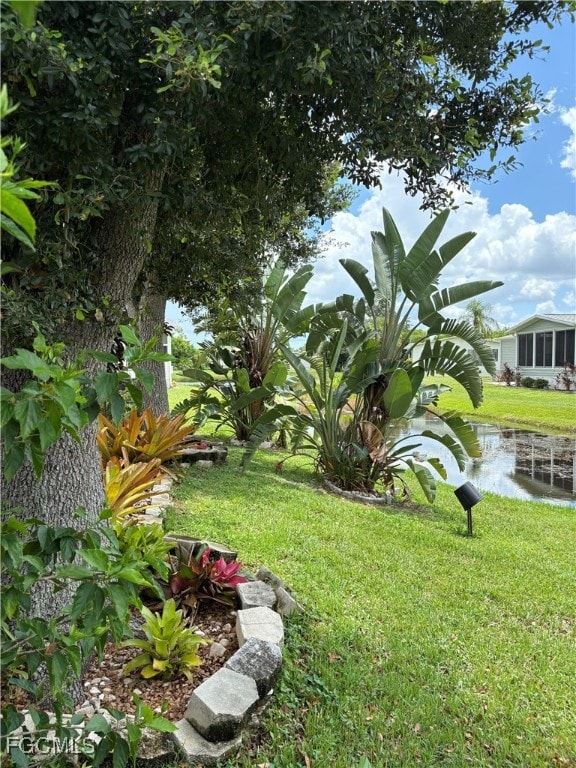 View of grassy yard with a water view