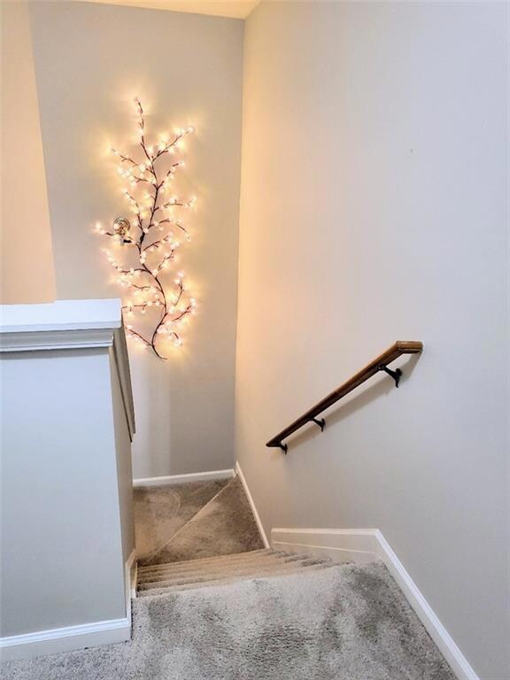 Stairway to bedrooms and two full bathrooms