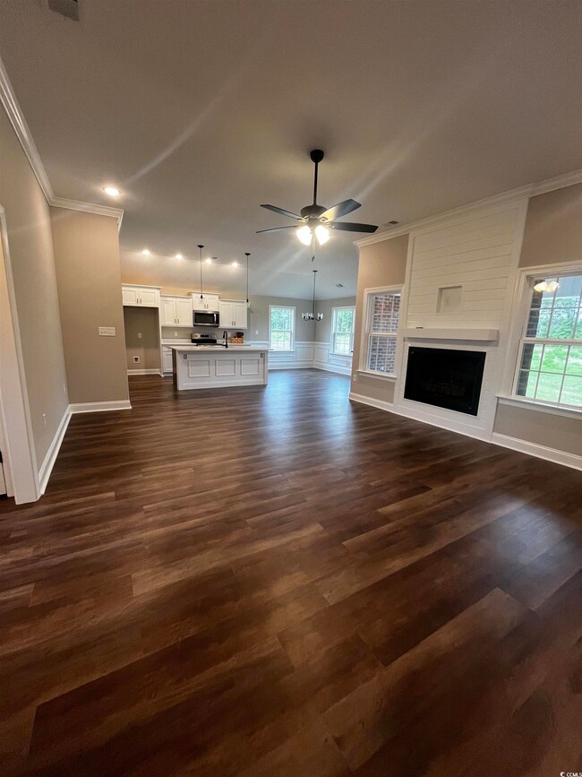 Unfurnished living room featuring ornamental moldi