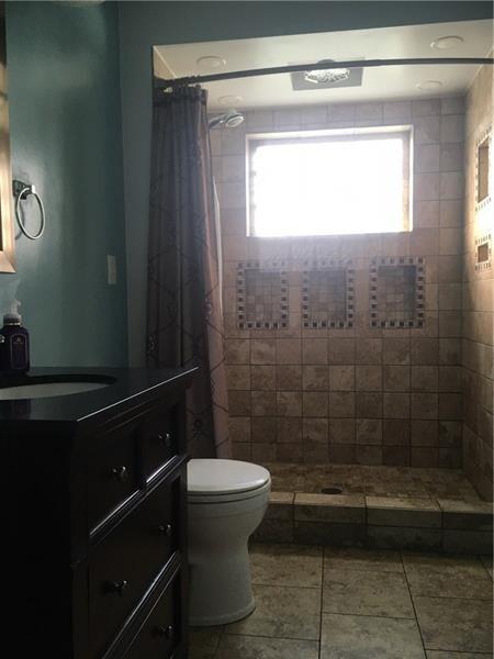 Remodeled first floor bathroom with step in tile s