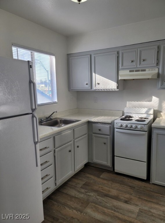 Kitchen with white appliances, under cabinet range