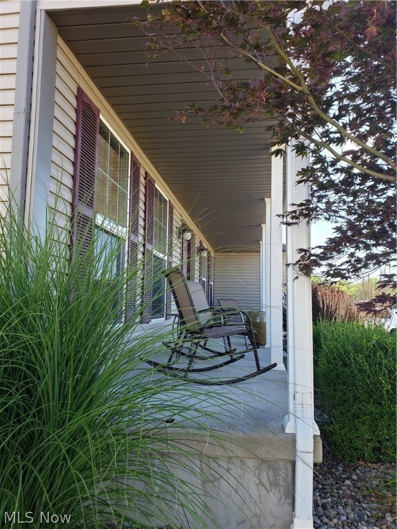 Peaceful front covered porch & chairs ready for a glass of tea