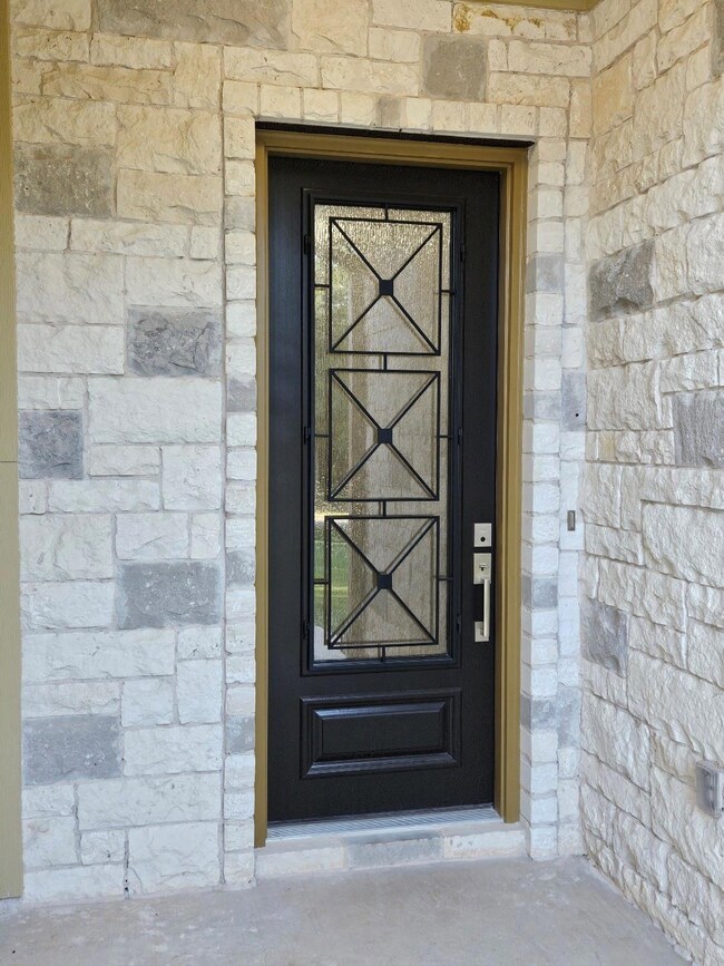 View of exterior entry with stone siding