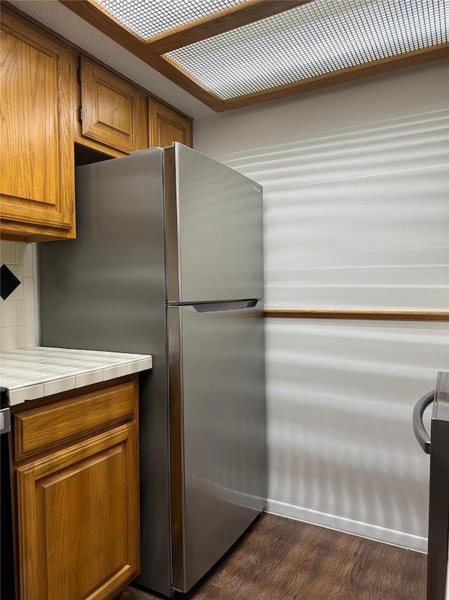 Kitchen featuring tile countertops, stainless stee