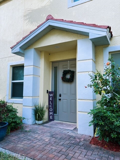 Property entrance featuring stucco siding