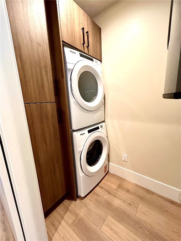 Laundry area featuring stacked washer / drying mac