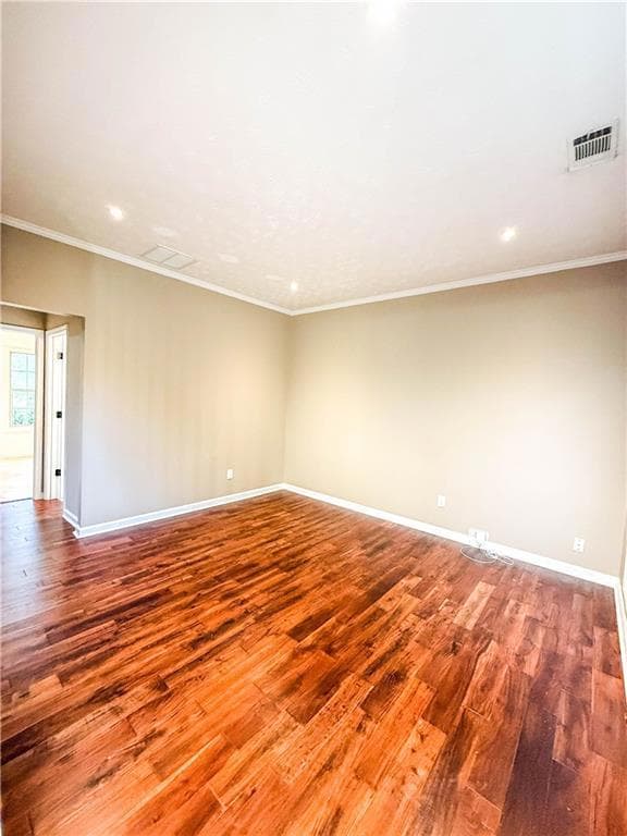 Empty room featuring crown molding, wood finished floors, a textured ceiling, and recessed lighting