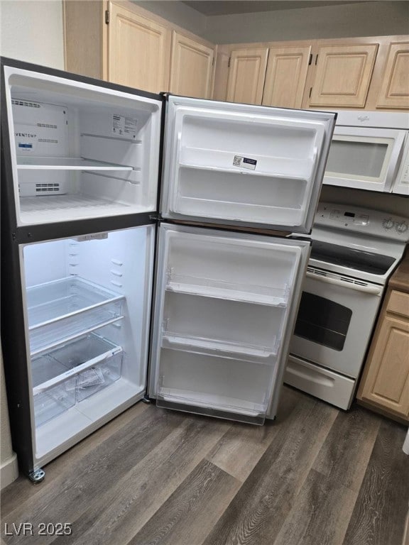 Kitchen with white appliances, dark wood-style flo