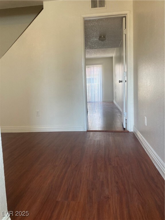 Empty room with wood finished floors and a texture
